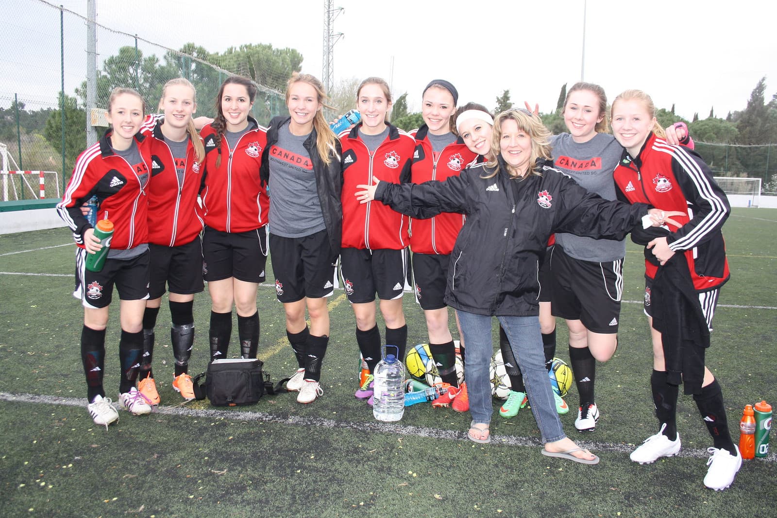 Happy youth soccer girls team after a development match in Spain