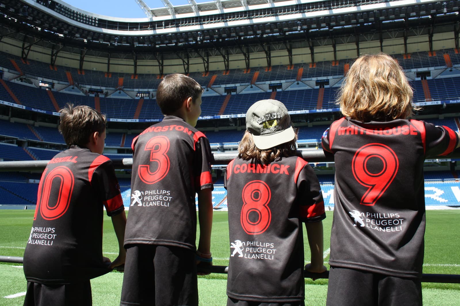 Young soccer players inspired at Santiago Bernabeu stadium in Madrid