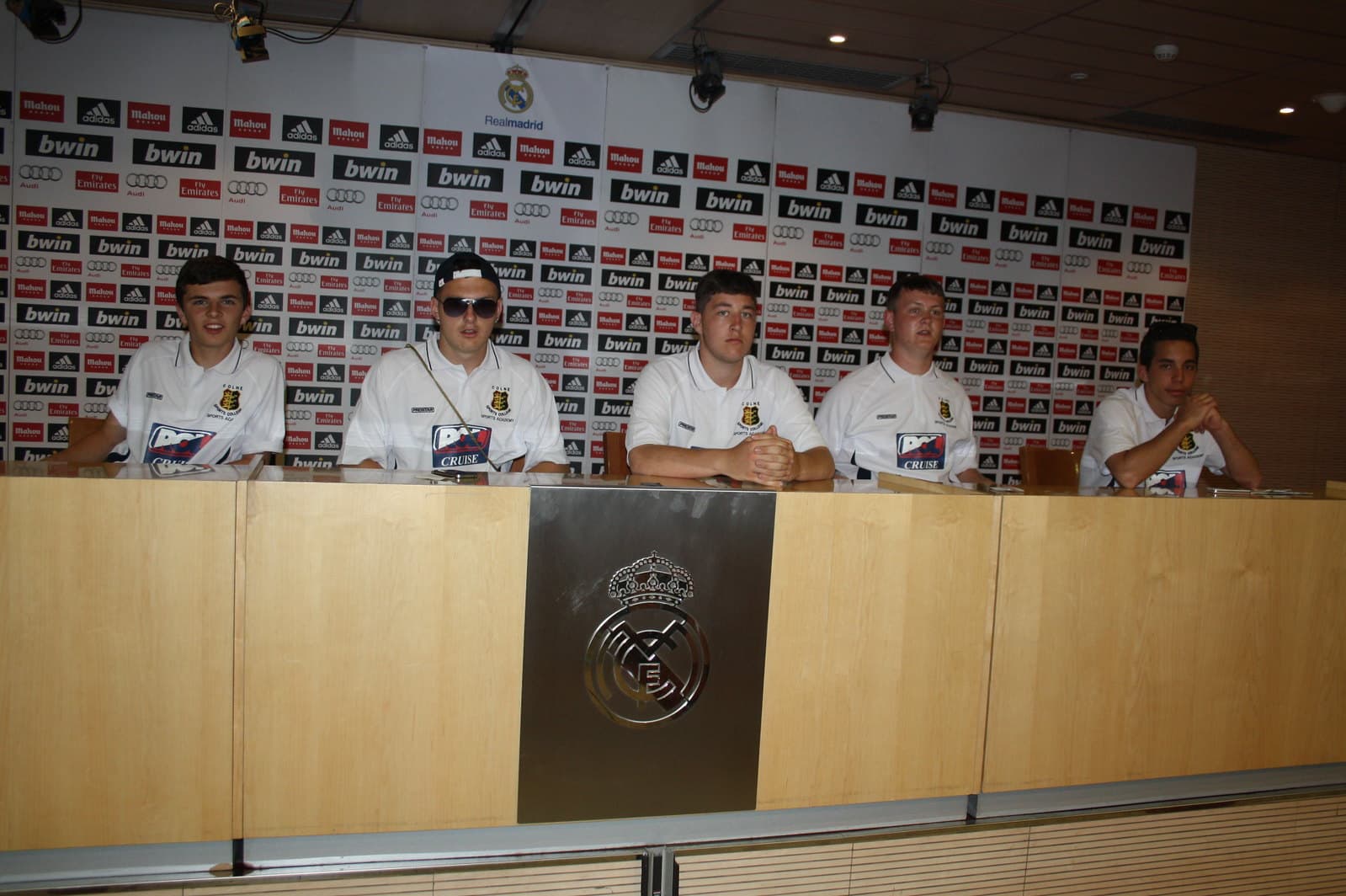 Youth soccer team in the Real Madrid Bernabeu press room during a stadium tour